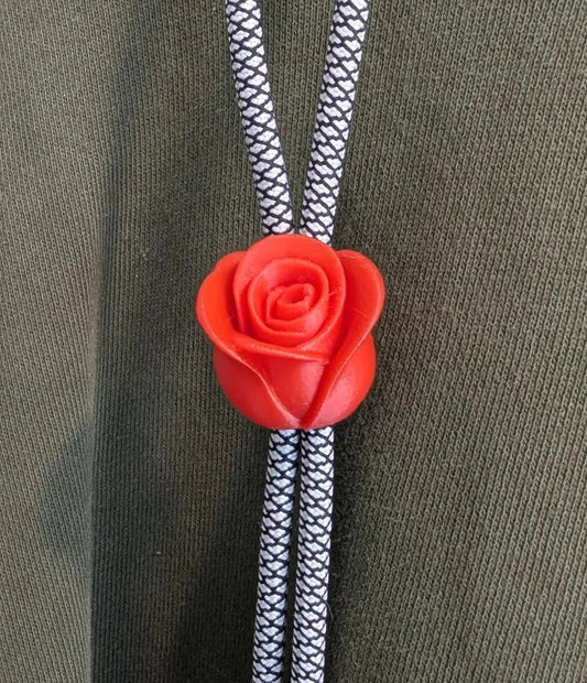 Red rose-shaped bolo tie on a green hoodie